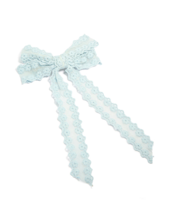 Crafted from floral fabric with bow design in powder blue, this hair clip features scalloped edge detailing, front view