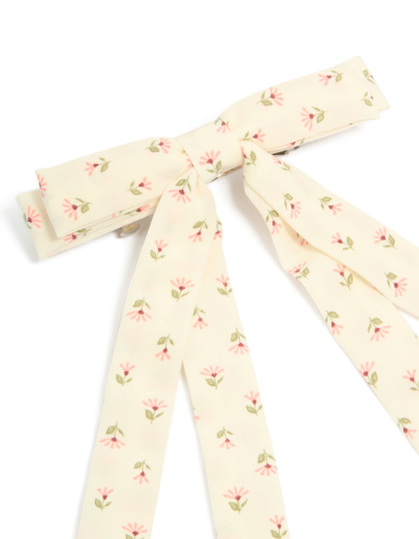 Featuring a cream pink flowers printed fabric bow clip with ivory and light pink olive drab leaf accents side view