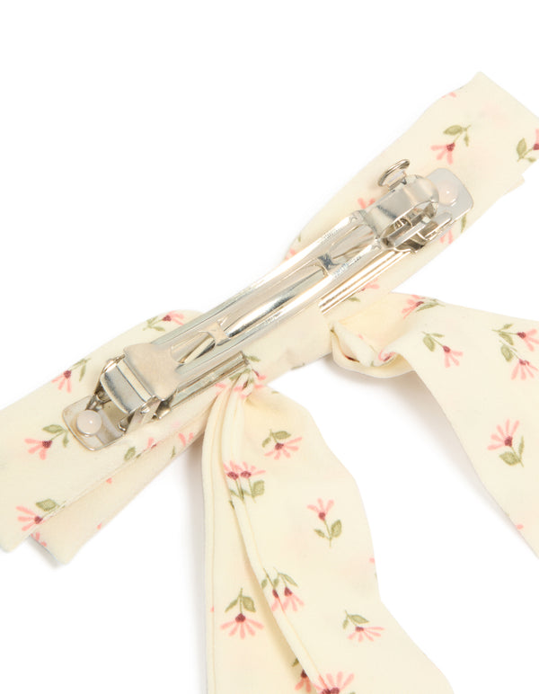 Crafted from cream pink flowers printed fabric, this bow clip reveals metal clasp hardware in ivory and light pink with olive drab leaf accents detail view