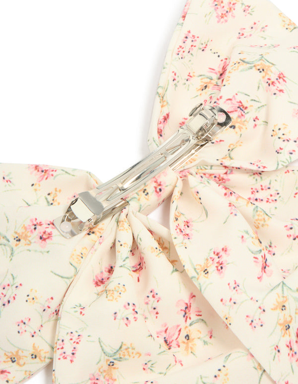 Floral printed fabric bow clip with leaf accents detail in ivory, light pink, peachpuff, and pale green showcasing clasp mechanism detail view