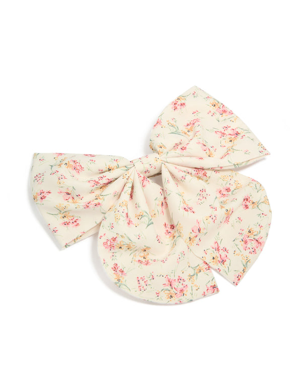 Charming printed fabric bow clip featuring floral bunches with leaf accents in ivory, light pink, peachpuff, and pale green front view