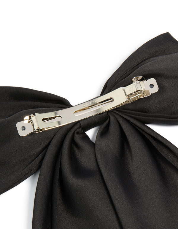 Designed with a bow in solid black and silver closure this hair clip detail view