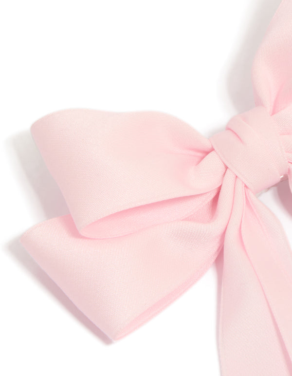 Designed with a bow in solid print featuring light pink statement hair clip side view
