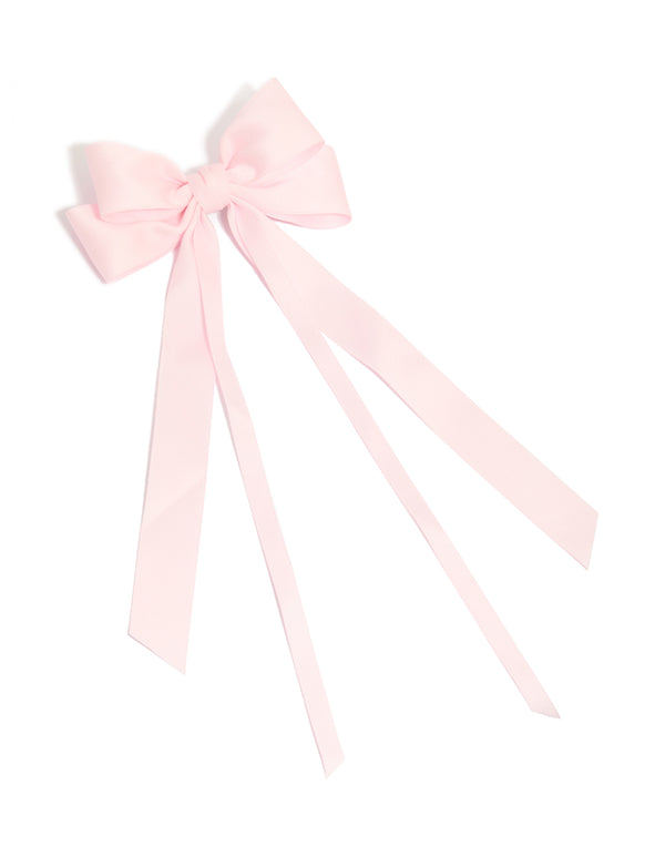 Crafted from fabric featuring a bow in solid print with light pink statement hair clip front view