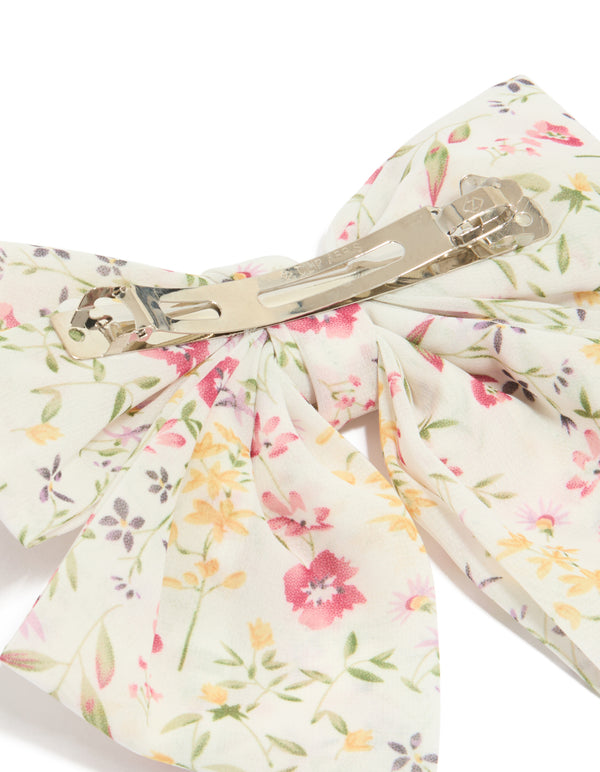 Crafted as a bow clip featuring floral print with leaf accents in ivory, pink, light goldenrod yellow, and olive side view