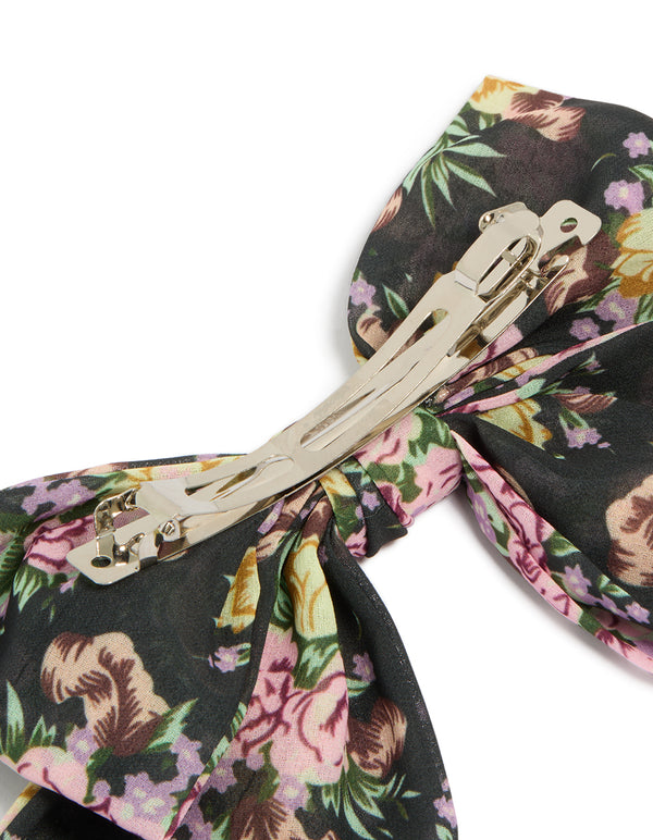 Featuring a large bow clip with printed flowers in black, pink, green, designed with statement style side view