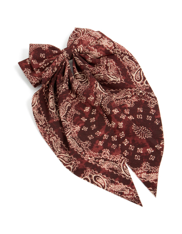 Beautifully crafted bow hair clip featuring paisley print in maroon, brown with statement styling front view