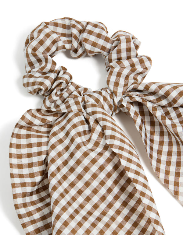 Featuring a checkered fabric scrunchie scarf in saddle brown and white side view
