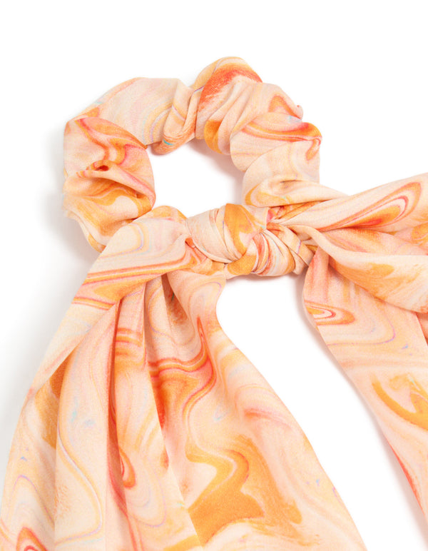 Showcasing an abstract print in peachpuff, darkorange, this orange marbled fabric scarf scrunchie delivers statement style side view