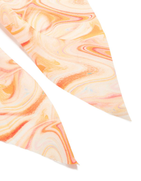 Crafted with an abstract print in peachpuff, darkorange, this orange marbled fabric scarf scrunchie makes a statement detail view