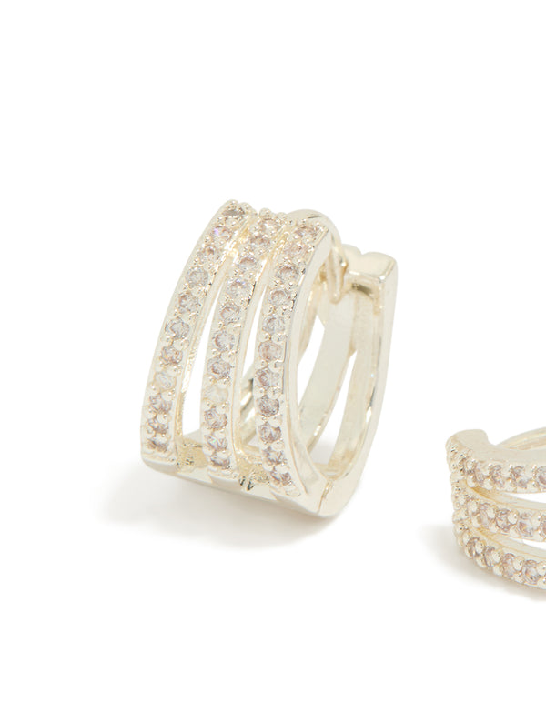 Highlighting trio layered huggie earrings with cubic zirconia in silver plated finish close up view