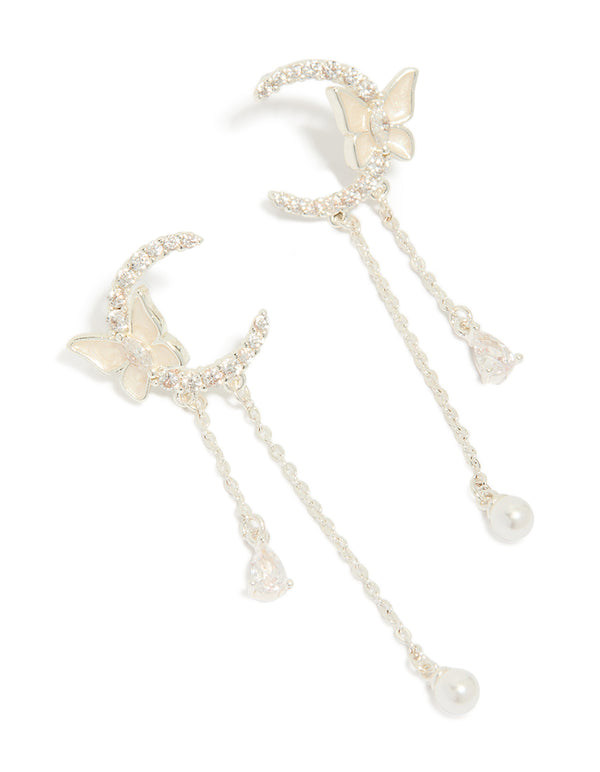 Showcasing silver plated cubic zirconia moon and butterfly drop earrings featuring celestial charm with pearl accents front view