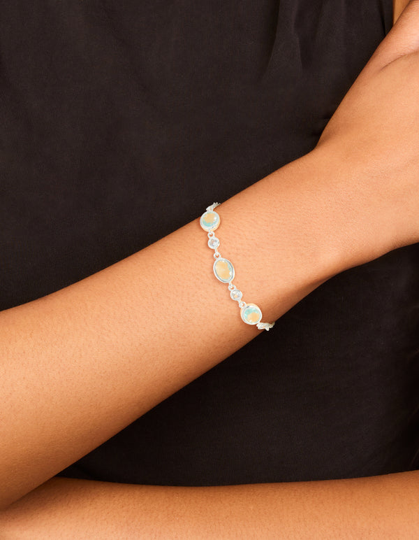 Featuring a silver plated blue cubic zirconia large bezel trio toggle bracelet with statement design on wrist view
