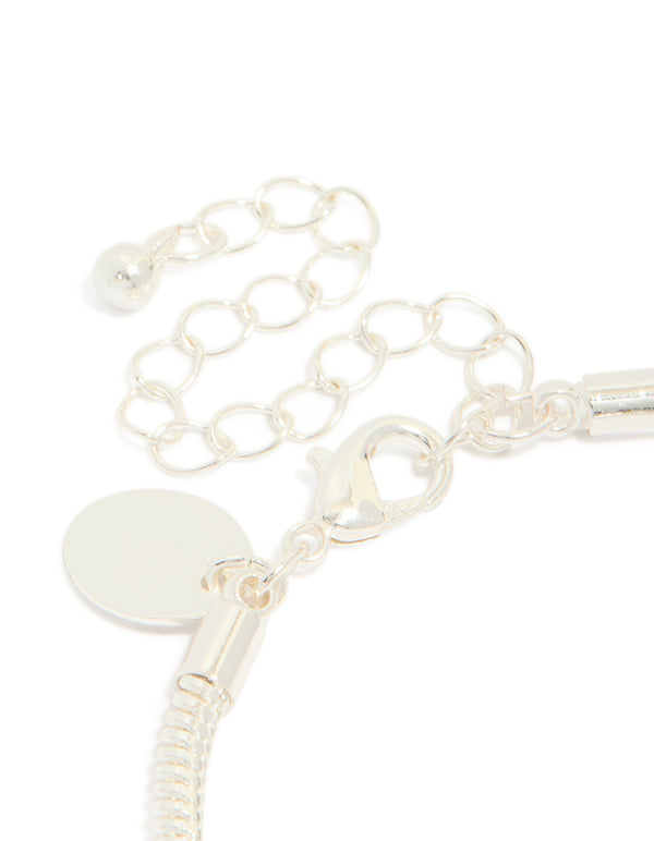 Highlighting the dainty silver plated bow charm bracelet with cubic zirconia and heart details on closure detail view