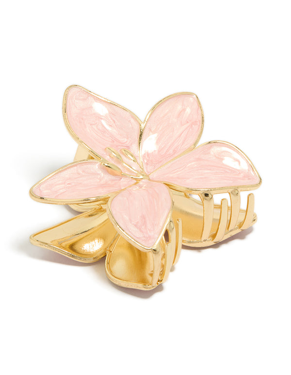 Showcasing a floral enamel claw clip in light pink and gold front view