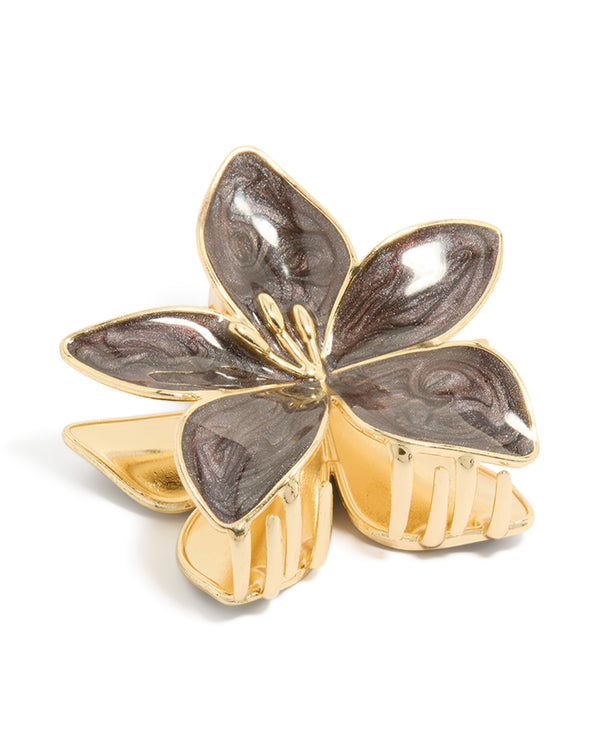 Crafted from enamel, this floral frangipani flower stem claw clip features marbled brown in gold front view