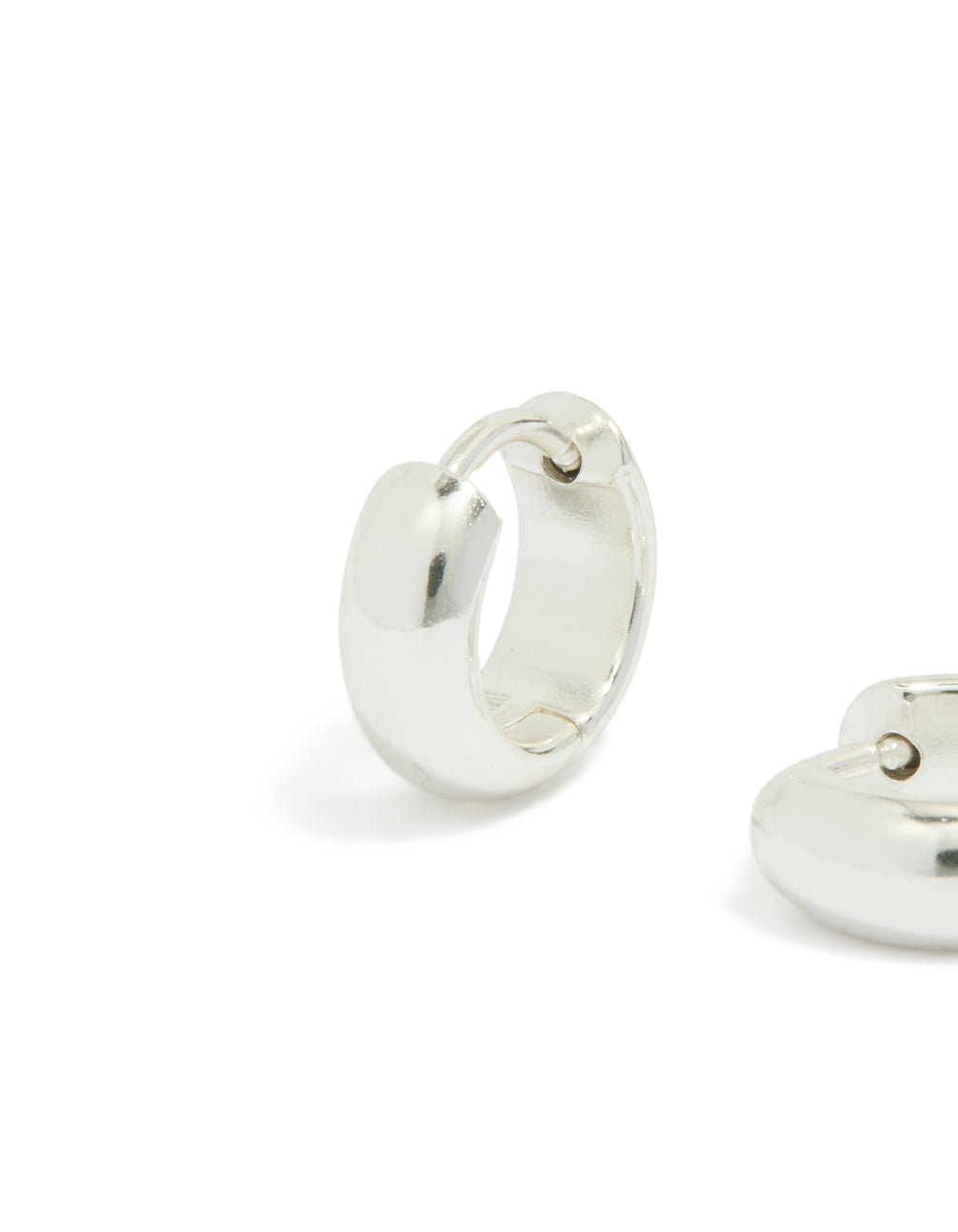 Highlighting chunky waterproof silver plated stainless steel huggie earrings with detailed closure close up view