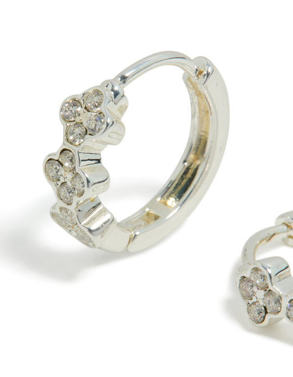 Showcasing dainty waterproof stainless steel cubic zirconia triple flower huggie earrings with crystal accents in silver close up view