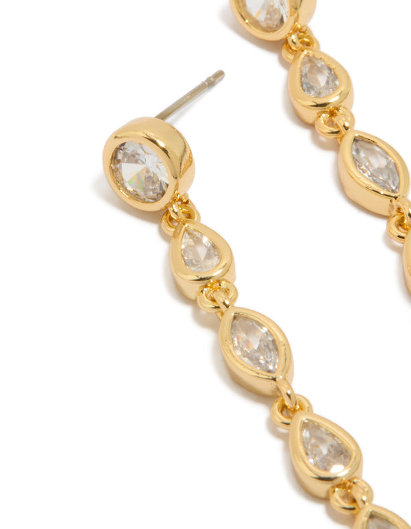 Highlighting statement long drop earrings featuring cubic zirconia in mixed shapes and gold plated finish close up view