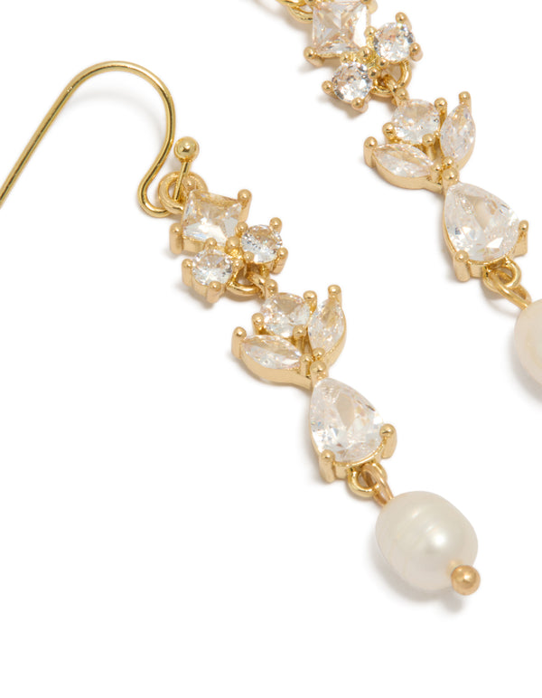 Showcasing gold plated cubic zirconia and freshwater pearl vine hook drop earrings featuring charm accents close up view