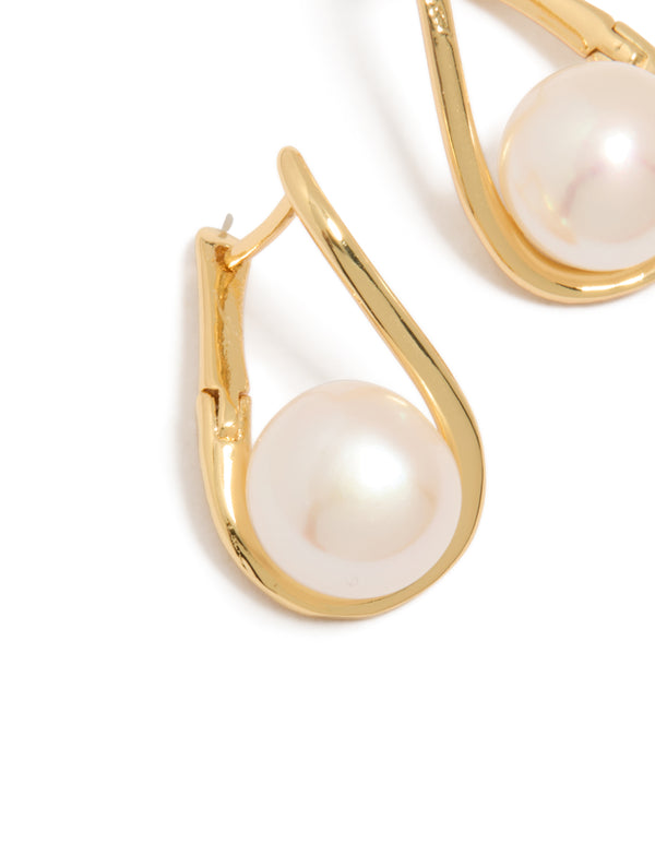 Featuring gold plated freshwater pearl twist hoop earrings with ivory accents close up view