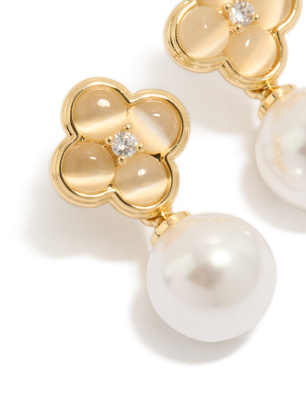 Showcasing gold plated pearl and flower drop earrings with floral detailing in white and ivory close up view