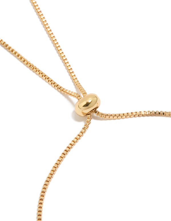 Highlighting the gold plated toggle closure with clear and pink cubic zirconia flowers bracelet closure detail view
