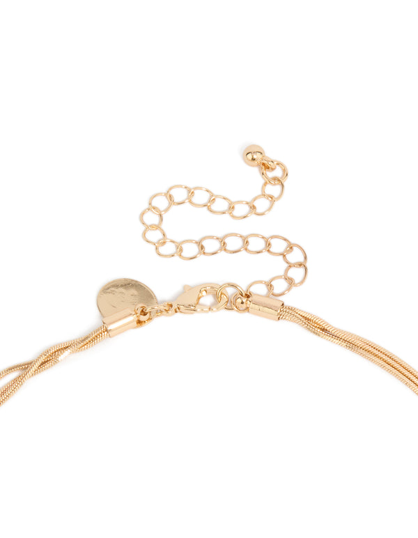 Highlighting gold long snake tassel necklace clasp detail view