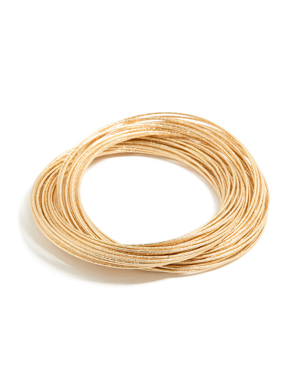 Worn gold multi crossover bangle front view