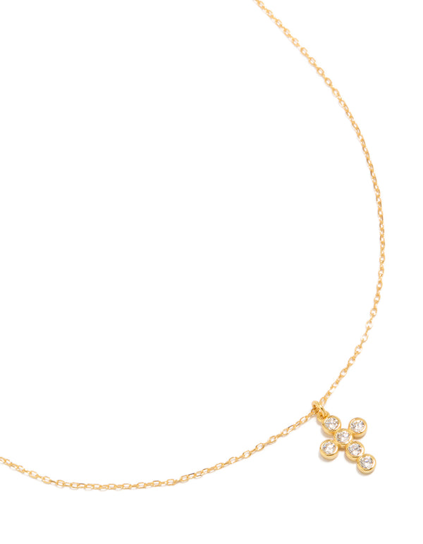 Showcasing a cross pendant necklace crafted from cubic zirconia with sterling silver and gold plated finish close up view