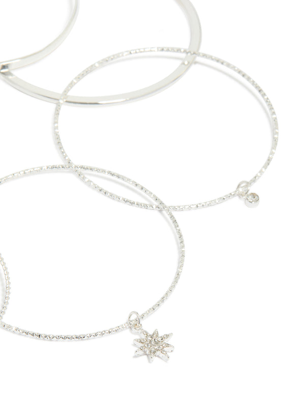 Designed with silver celestial charm bangles featuring diamante moon and star accents in a statement 7-pack set closure detail view