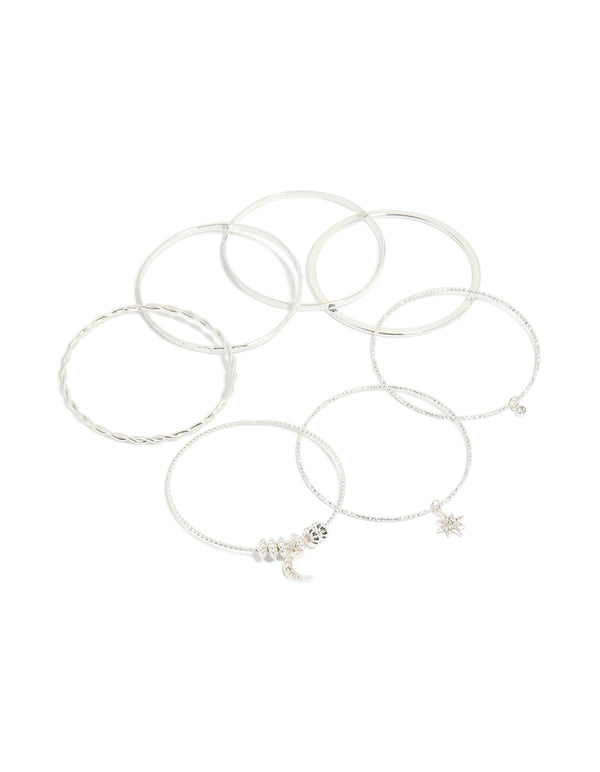 Showcasing celestial charm bangles featuring diamante moon and star accents in a statement 7-pack set front view