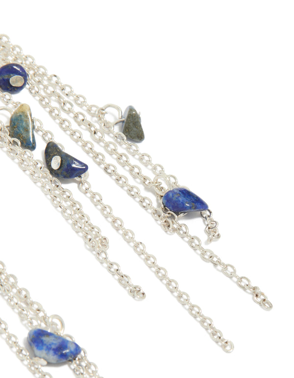 Designed with statement style these silver drop earrings with crescent design, beaded details, semi precious stones and tassel accents in post detail view