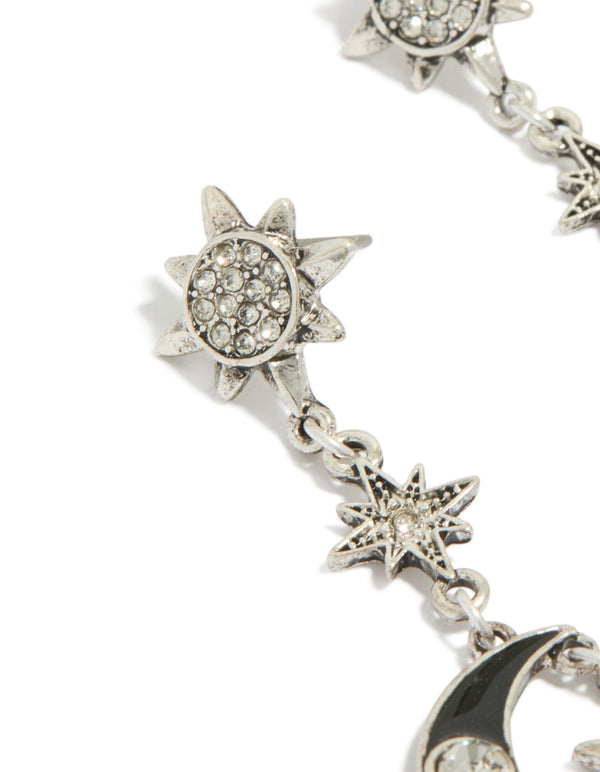 Showcasing antique silver edgy star moon drop earrings with celestial charm details close up view