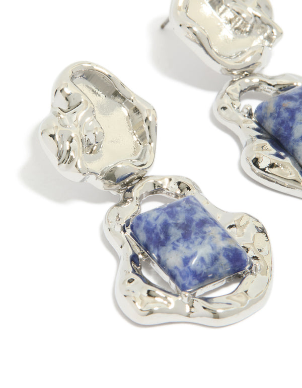 Beautifully crafted silver molten semi precious stone drop earrings with blue gemstones and detailed metalwork close up view