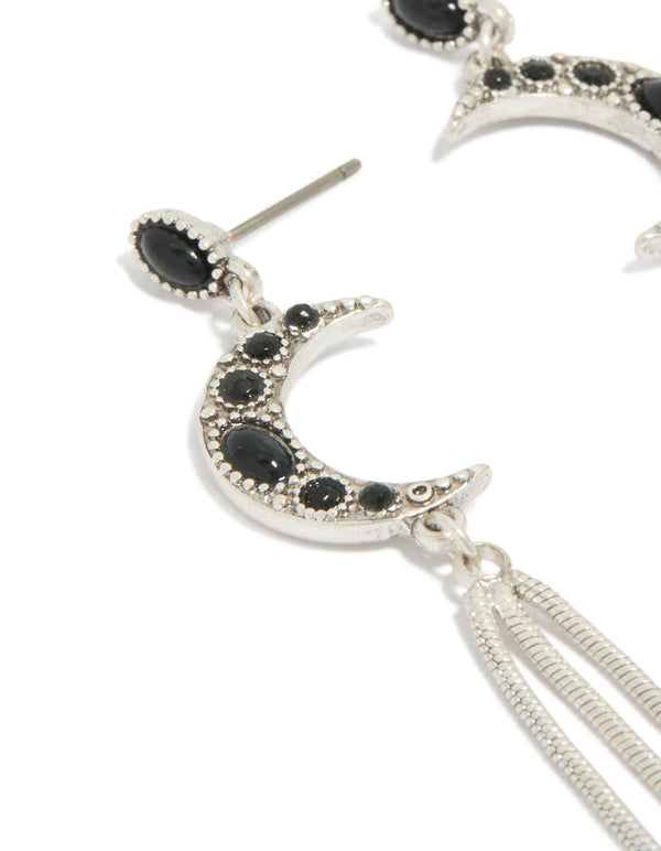 Elegant dainty silver drop earrings featuring celestial moon with black gemstone accents and tassel chain detailing close up view