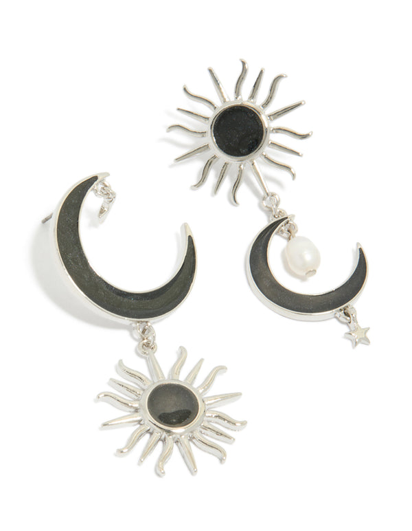 Showcasing statement silver black drop earrings featuring moon and sun celestial design with pearl accents front view
