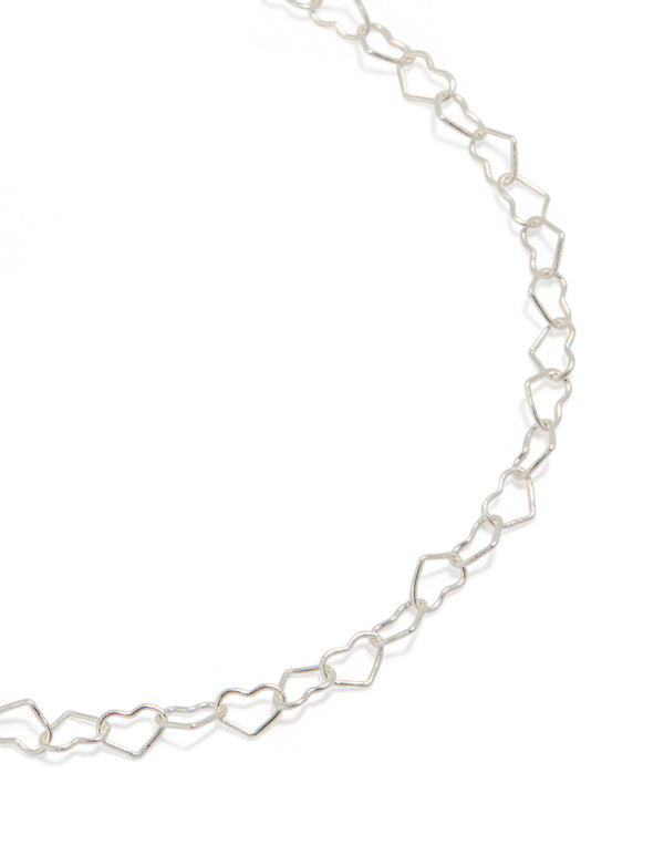 Showcasing sterling silver heart link bracelet in a close up view