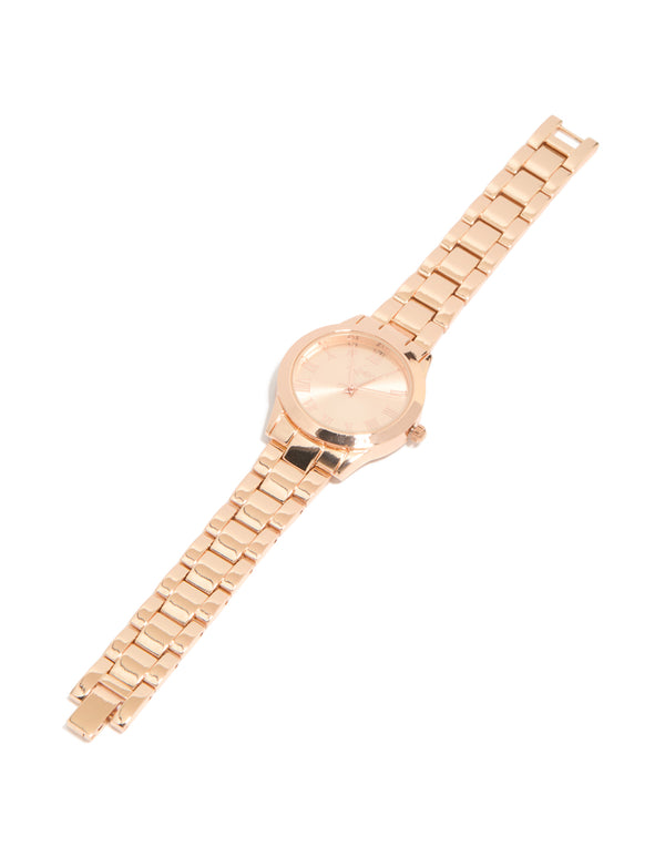 Elegant rose gold classic round roman numeral watch featuring numbers, pink dial, women's link band, formal occasion, analog timepiece front view