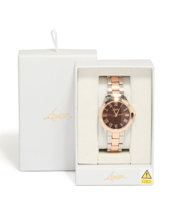 Elegant mixed metal watch with brown roman numeral dial, round shape, formal occasion, women's analog timepiece, link band in multi-color, gold and silver tones case detail view
