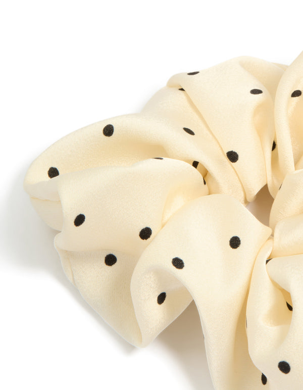 Designed with polka dot pattern in cornsilk and black statement fabric scrunchie detail view