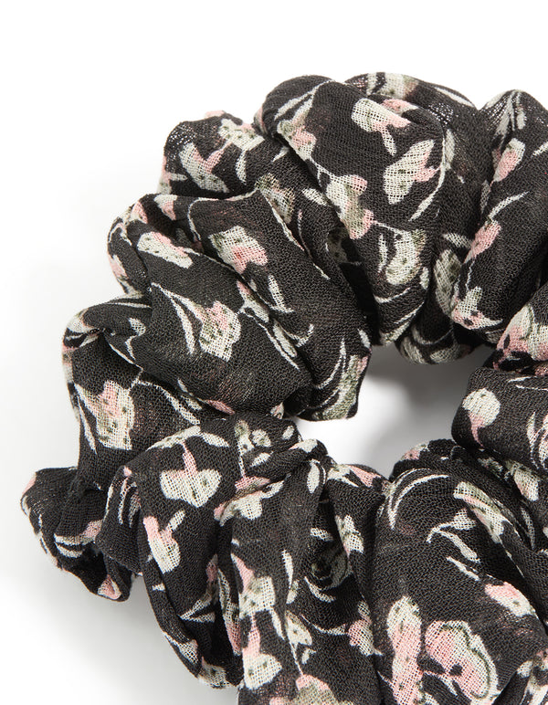 Featuring scattered floral printed statement scrunchie in black, light pink, beige detail view