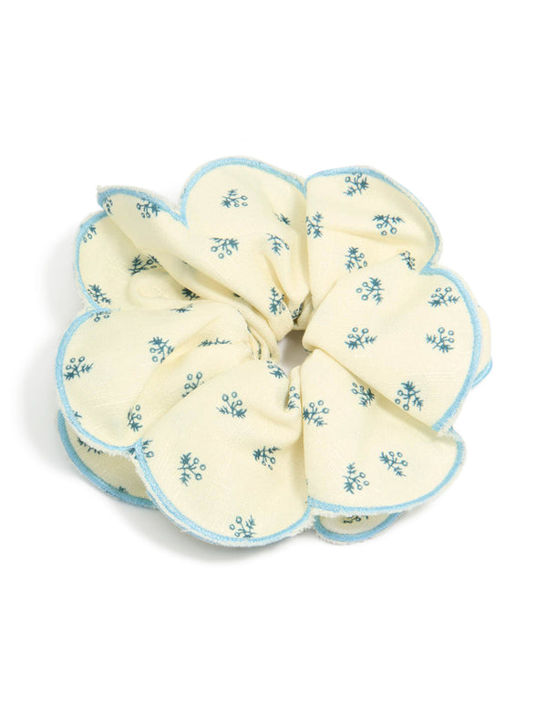 Showcasing a ruffled scrunchie with floral print in ivory, sky blue and teal front view
