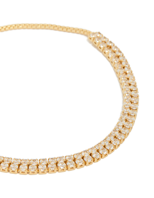 Showcasing a gold plated thin double cubic zirconia tennis toggle bracelet close up view