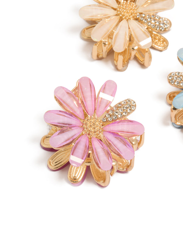 Showcasing glitter floral print 3-pack gold pastel daisy claw clips in pink, powder blue, and peachpuff detail view