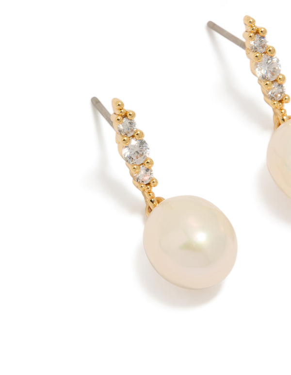 Elegant statement gold plated cubic zirconia and freshwater pearl drop earrings close up view