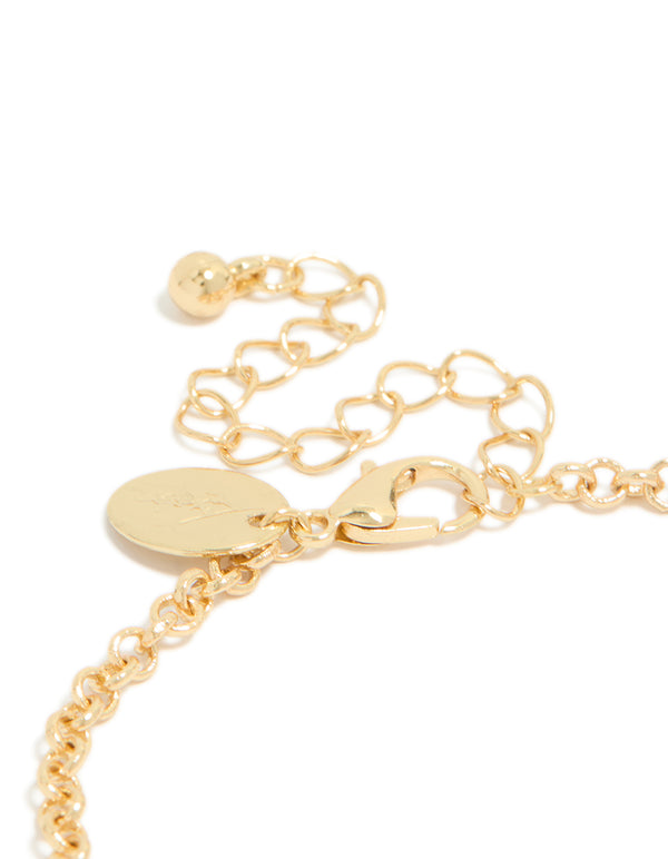 Highlighting a gold plated bracelet with cognac beads and clear cubic zirconia in a tennis style closure detail view