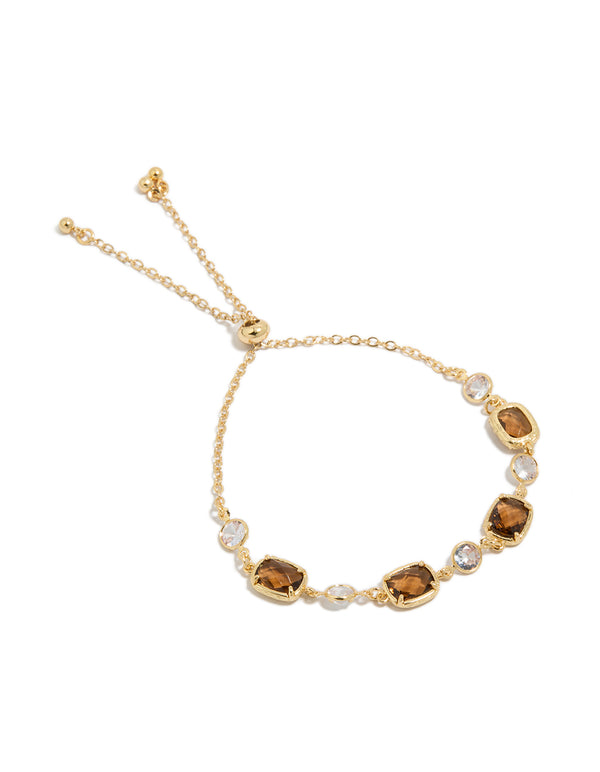 Showcasing a gold plated clear and cognac cubic zirconia square cut bezel toggle bracelet front view