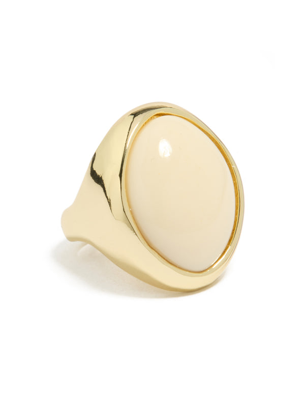 Showcasing a gold plated oval cream stone ring with statement styling front view