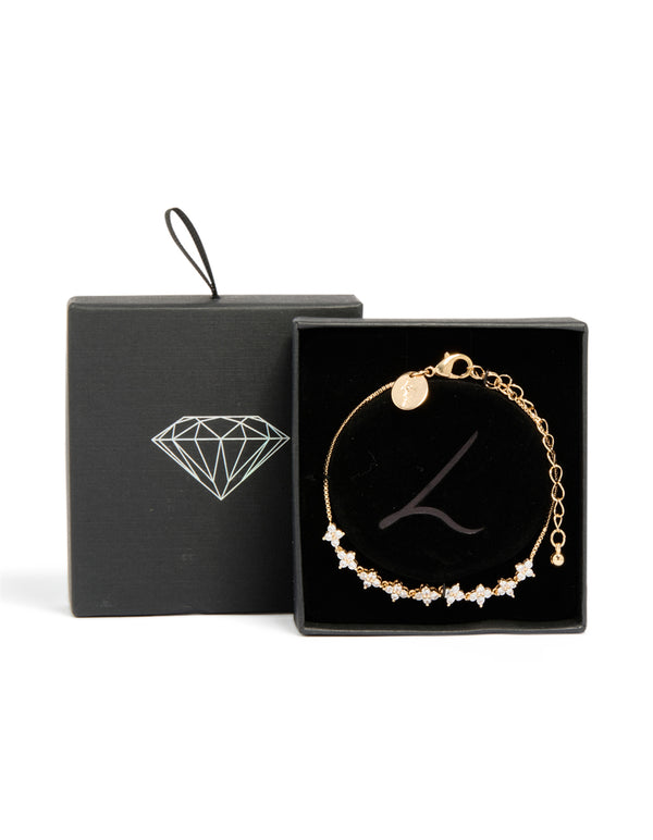 Featuring a floral cubic zirconia bracelet in gold with a statement style close up view